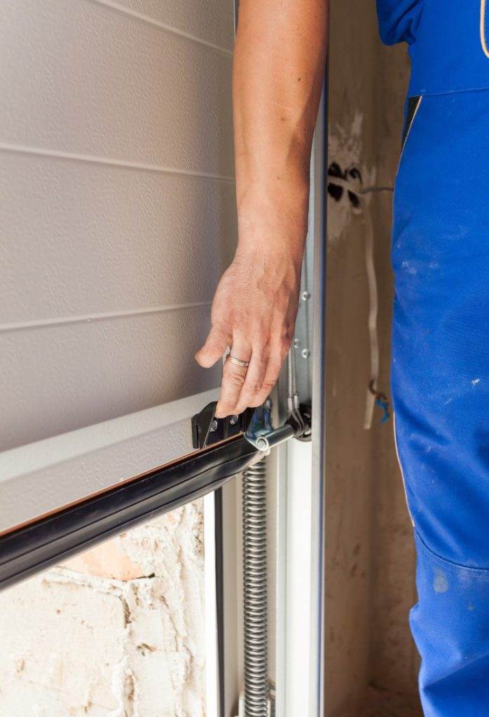 Skilled worker installing a sliding door mechanism in residential construction project Skilled worker installing a sliding door mechanism in residential construction project