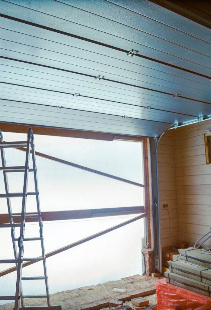Construction of an Industrial Building with Steel Ceiling Installation in Progress at a Commercial Site Construction of an Industrial Building with Steel Ceiling Installation in Progress at a Commercial Site