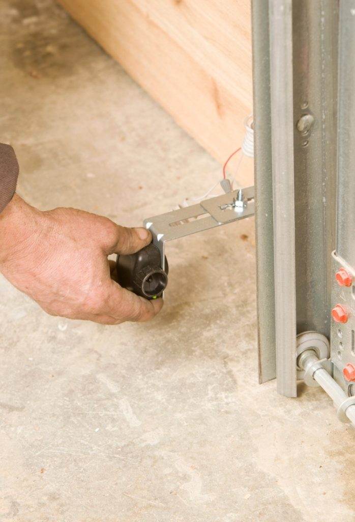 Hand adjusting metal track component for wall installation in construction project Hand adjusting metal track component for wall installation in construction project