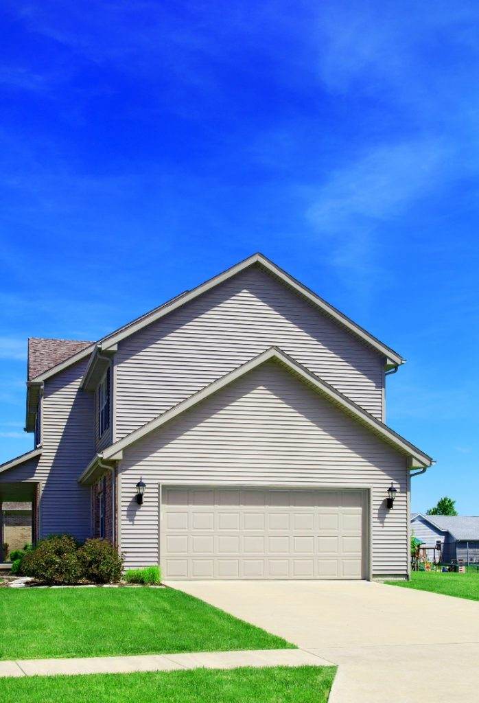 Modern residential home with well-maintained lawn and clear blue sky during a sunny day Modern residential home with well-maintained lawn and clear blue sky during a sunny day