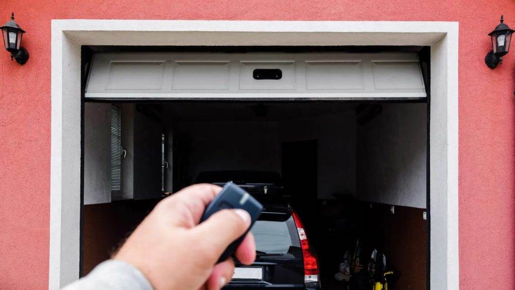 Opening a garage door with a remote control in a residential setting Opening a garage door with a remote control in a residential setting