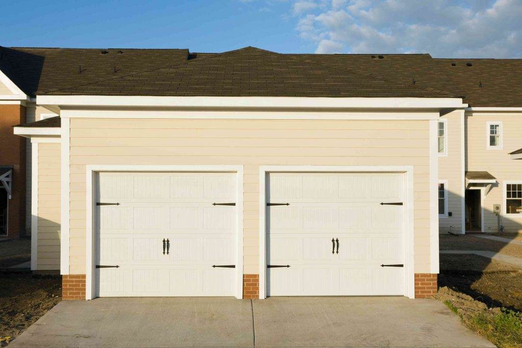 New residential garage showcasing modern design and clean lines in a suburban neighborhood during sunset New residential garage showcasing modern design and clean lines in a suburban neighborhood during sunset
