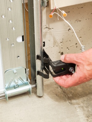 Garage door repair service addressing track issues in Edmonton during afternoon maintenance Garage door repair service addressing track issues in Edmonton during afternoon maintenance
