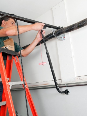 Expert technician installs modern steel garage doors in Edmonton location with precision and care Expert technician installs modern steel garage doors in Edmonton location with precision and care