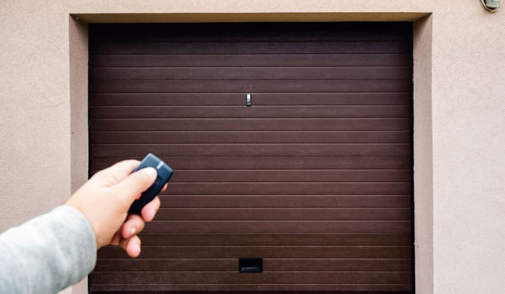 Garage door technician repairing opener receiver